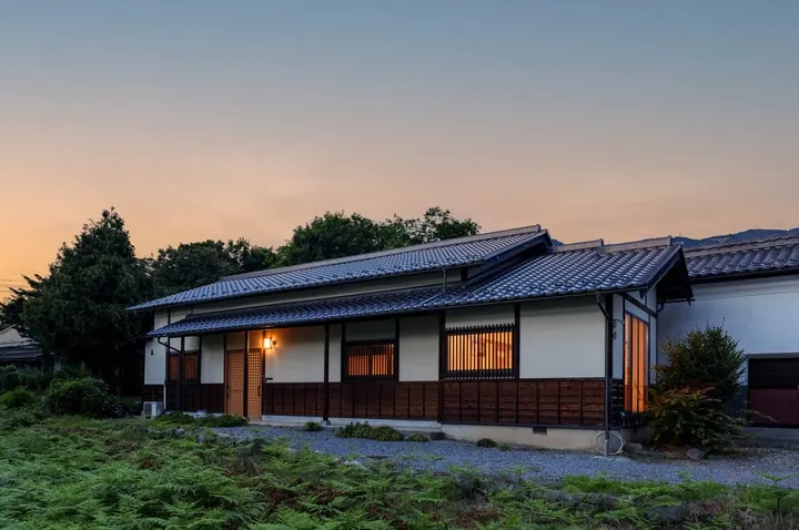 夕暮れに明かりが灯る和風の住まい